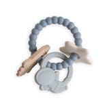 Mushie Space Teething Ring, a blue beaded silicone ring with a planet, rocket and star charms