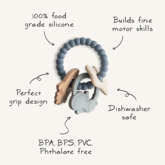 Mushie Space Teething Ring with feature callouts: food grade silicone, grip design, fine motor skills, dishwasher safe