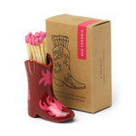 Paddywax Cowboy Boot Match Holder in Red & Pink Flame, a red ceramic boot with pink flames beside its kraft box