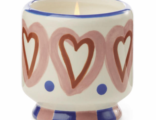 Cream ceramic candle hand painted with pink and rust hearts and a cobalt rim