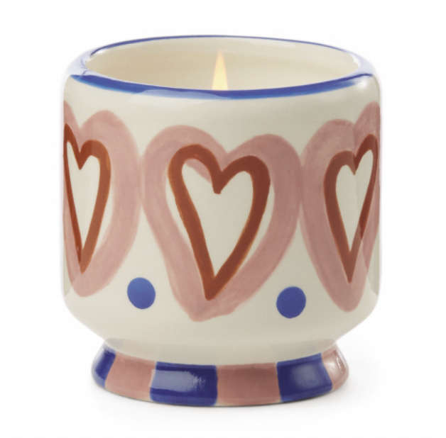 Cream ceramic candle hand painted with pink and rust hearts and a cobalt rim