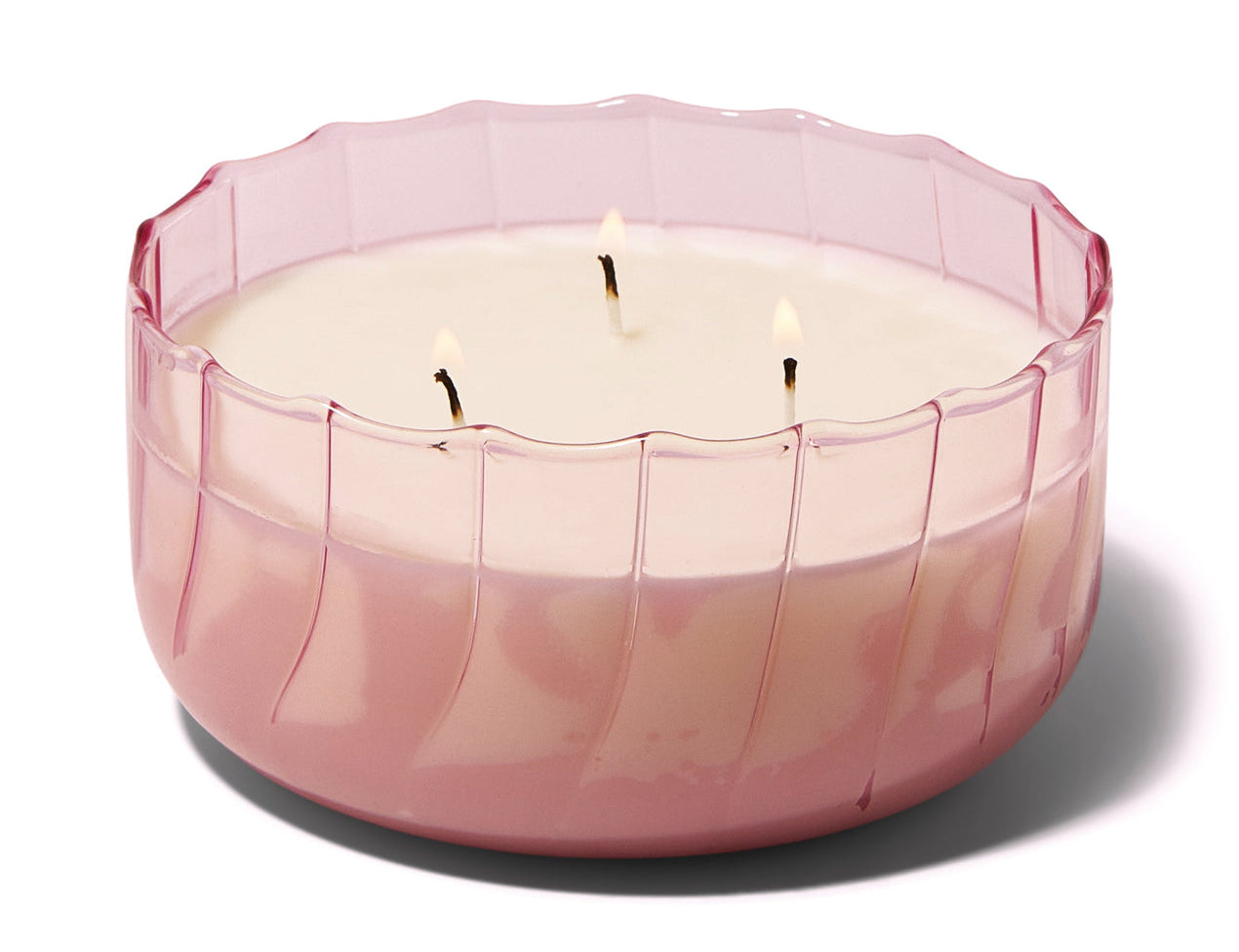 Wide ribbed peach pink Paddywax Ripple candle with three wicks