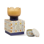 Paddywax Tulip Glass Candle in amber glass on its orange floral box with a matching travel tin