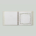 Paige Tate & Co As You Grow Memory Book, open spiral-bound spread with a growth tracking chart and botanical border
