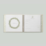 Paige Tate & Co As You Grow Memory Book, open spread with a leafy wreath and a fill-in milestone page