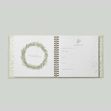 Paige Tate & Co As You Grow Memory Book, open spread with a leafy wreath and a fill-in milestone page