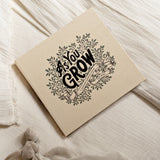 Paige Tate & Co As You Grow Memory Book lying on a soft cream blanket