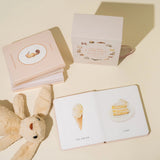 Paige Tate & Co Our Little Library Vol. 2 board books open beside a plush bunny