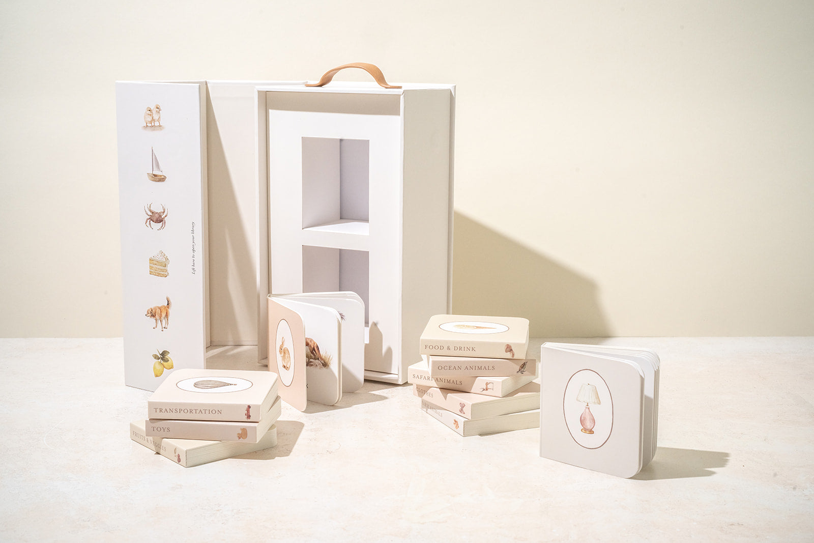 Paige Tate & Co Our Very Little Library carry box open with the mini board books laid out