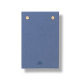 Papier Fabric Hardcover Notepad closed, showing the blue fabric cover with gold studs