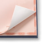 Close-up of a pink tear-off page lifting from the Papier Fabric Hardcover Notepad