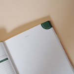 Papier Finance Planner Four Leaf open to a dotted notes page