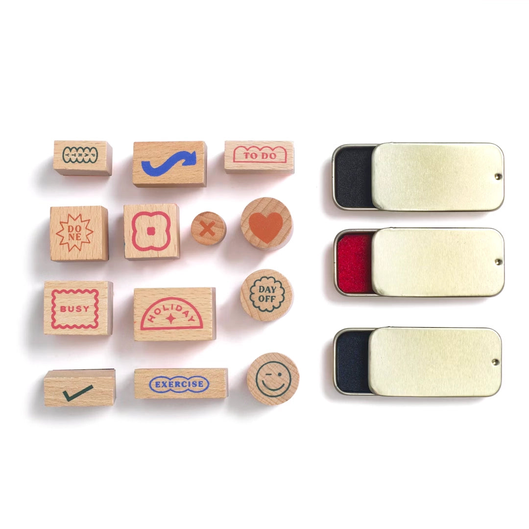Papier Good Day Stamp Planner Set stamps and three ink pads laid out on white