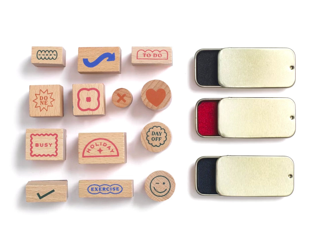 Papier Good Day Stamp Planner Set stamps and three ink pads laid out on white