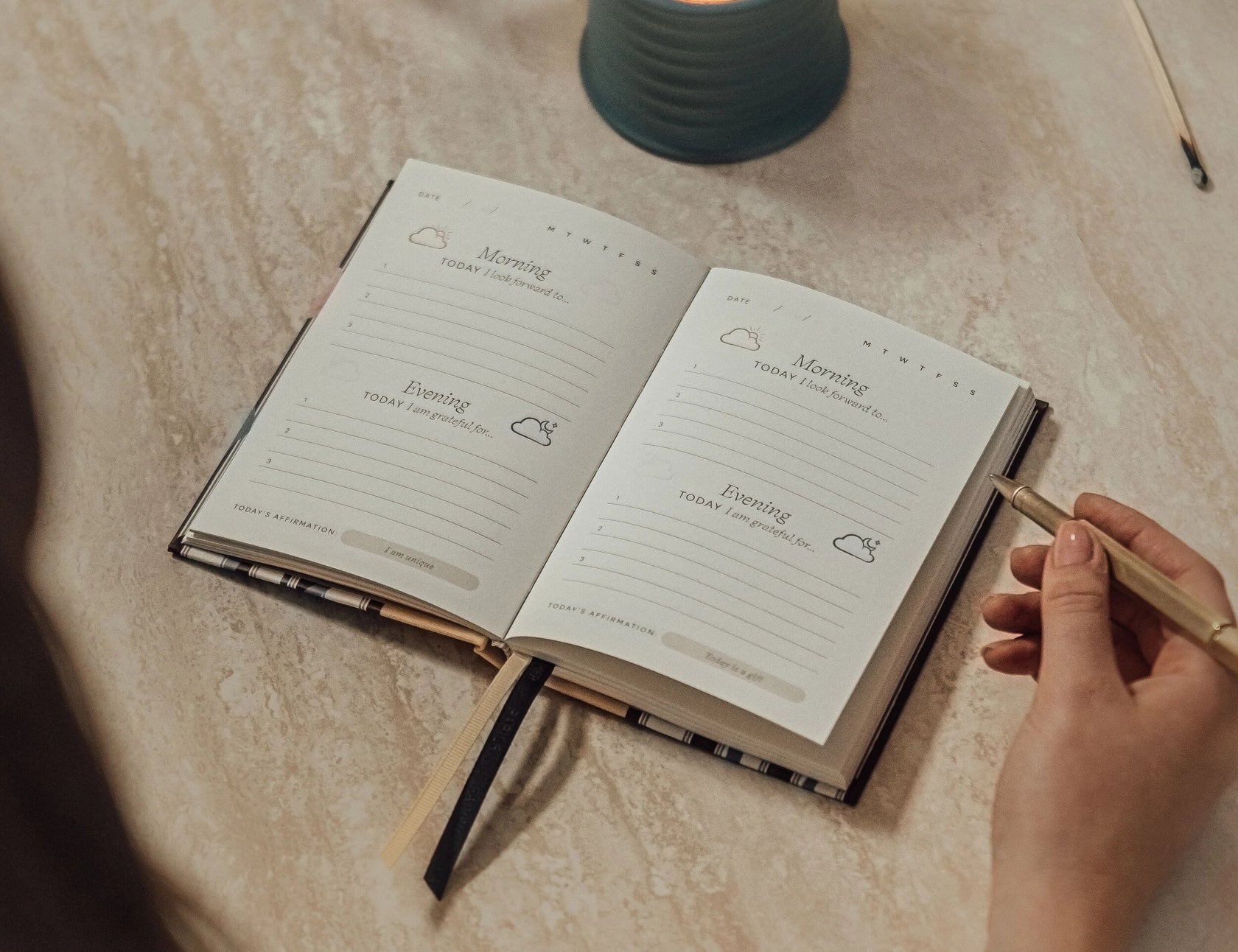 Papier Guided Gratitude Journal A6 Stripe Bouquet open on a table beside a lit candle