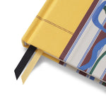 Close-up of the yellow fabric spine and ribbon bookmark on the Papier Guided Gratitude Journal A6 Stripe Bouquet