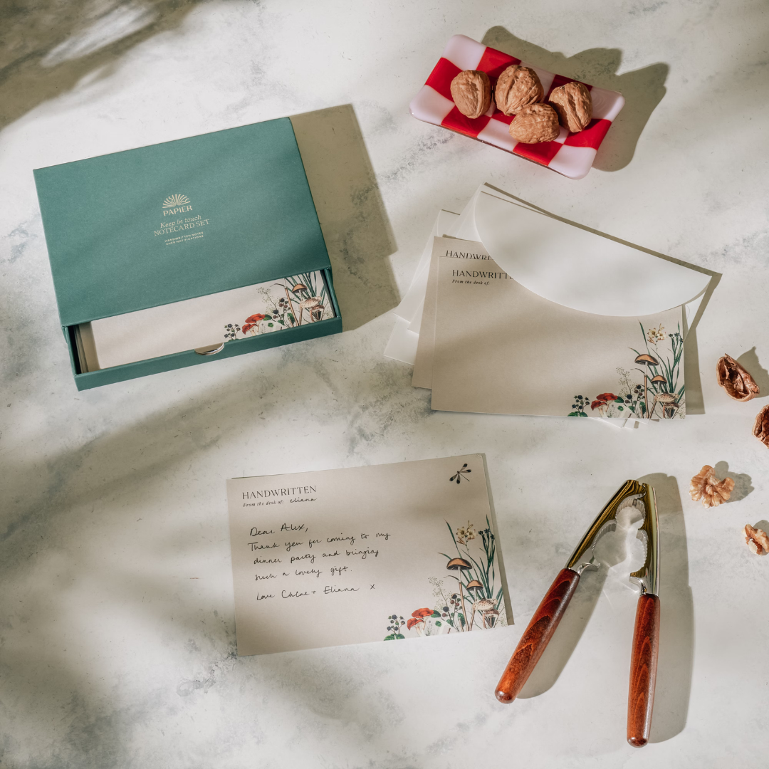 Papier Keep in Touch Notecard Set styled on a marble table with a written note and cookies