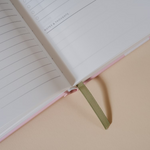 Papier My Daily Planner Wonder open to a Notes & Thoughts page with the green ribbon bookmark