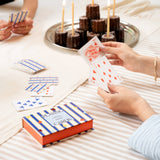 Papier Playing Cards Suits & Stripes on a picnic blanket with a tray of chocolate cakes