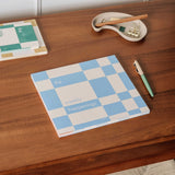 Papier Weekly Happenings List Pad on a wooden desk with a pen and notebooks, cover view