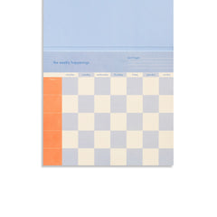 Papier Weekly Happenings Undated List Pad, a blue and cream checkerboard weekly planner pad with an orange edge