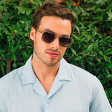 Man in a light blue shirt wearing Peepers Deep Dive Sunglasses in Fog outdoors