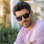 Man in a lavender sweater wearing Peepers Deep Dive Sunglasses in Mocha Tortoise