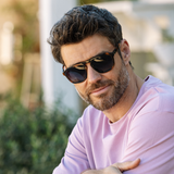 Man in a lavender sweater wearing Peepers Deep Dive Sunglasses in Mocha Tortoise