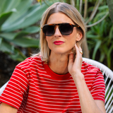 Woman in a red striped shirt wearing Peepers Deep Dive Sunglasses in Mocha Tortoise