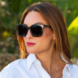 Woman in a white shirt wearing Peepers Frenchy Sunglasses in Green/Leopard Tortoise outdoors