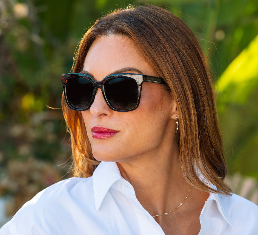 Woman in a white shirt wearing Peepers Frenchy Sunglasses in Green/Leopard Tortoise outdoors