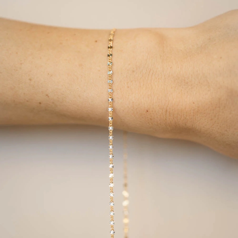 A gold filled permanent bracelet welded closed on a wrist, no clasp, fitted in store at Desert Sol in Moab.