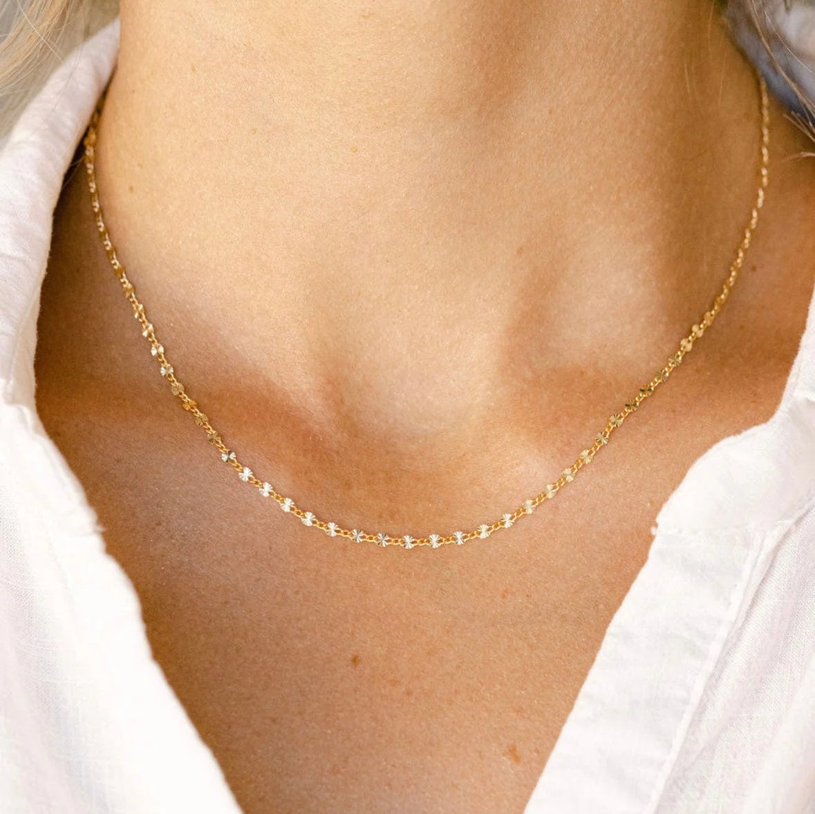 A gold filled permanent necklace welded closed at the neck and sized while worn, fitted in store at Desert Sol in Moab.