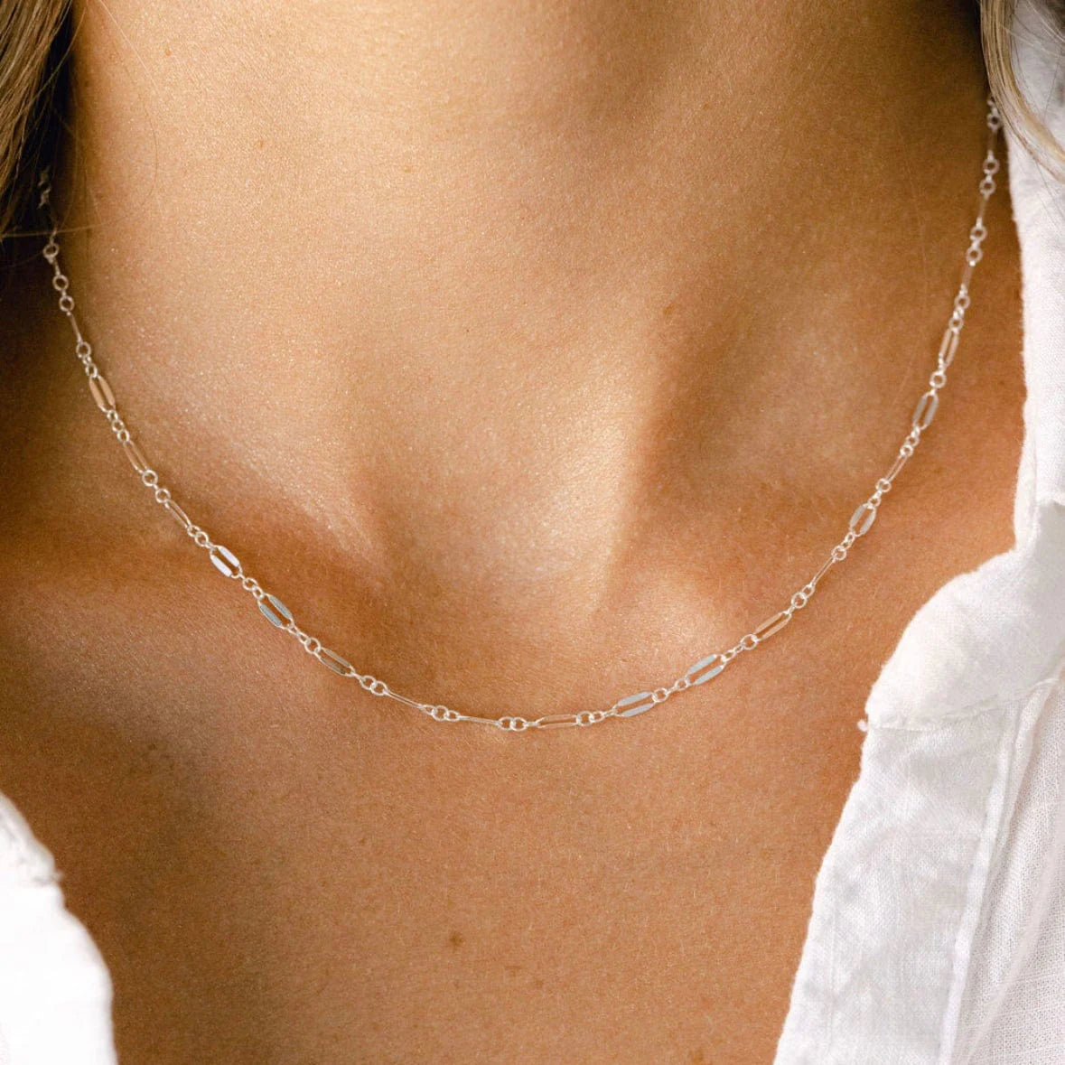 A sterling silver permanent necklace welded closed at the neck and sized while worn, fitted in store at Desert Sol in Moab.