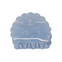 Petal claw clip in Moonstone, a translucent pale blue scalloped hair claw clip, on a white background.