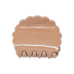 Petal claw clip in Rose Dust, a glossy dusty rose scalloped hair claw clip with the desert sol script embossed on top, on a white background.