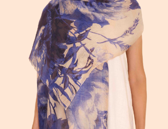 Powder Designs Linen Cotton Scarf in a blue and white floral print, draped over a model's shoulders