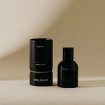Preston Cologne in Sandalwood, a matte black bottle beside its black cylinder box