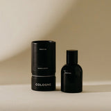 Preston Cologne in Sandalwood, a matte black bottle beside its black cylinder box
