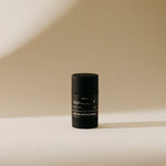 Preston Sunscreen Stick SPF 50, a matte black stick standing in warm light
