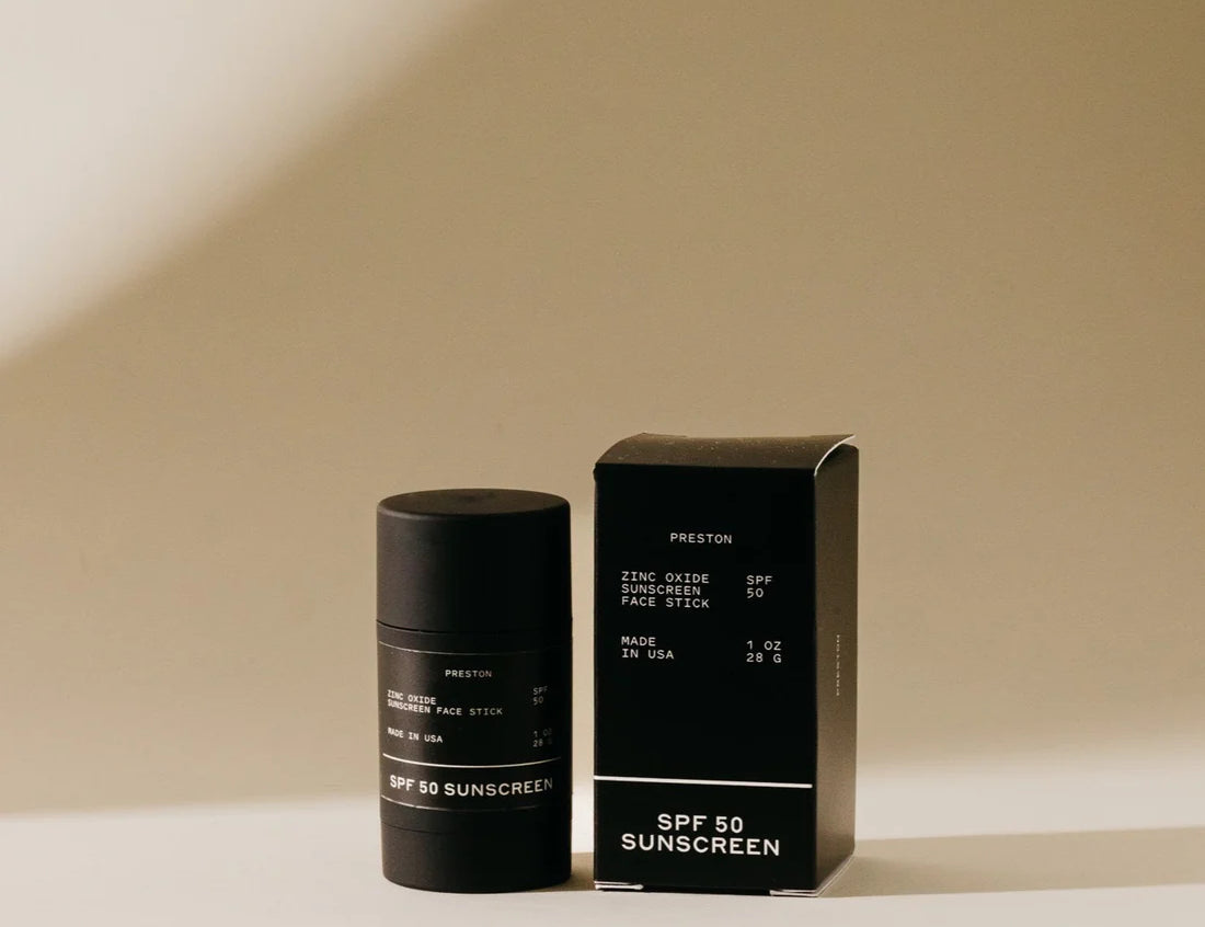 Preston Sunscreen Stick SPF 50, a matte black stick beside its black box