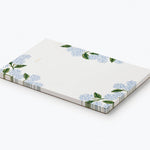 Rifle Paper Co. Hydrangea Memo Notepad shown at an angle with a striped edge