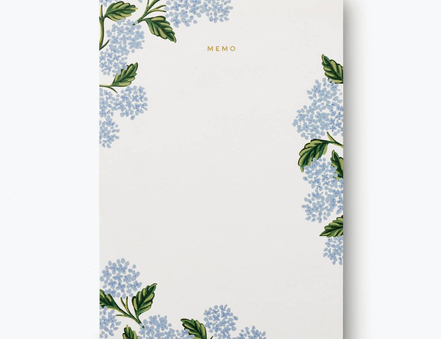 Rifle Paper Co. Hydrangea Memo Notepad, a cream pad with blue hydrangea illustrations in the corners