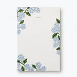 Rifle Paper Co. Hydrangea Memo Notepad, a cream pad with blue hydrangea illustrations in the corners