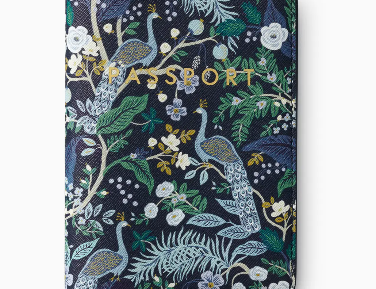 Rifle Paper Co. Peacock Passport Holder, a navy cover with a peacock and botanical print and gold lettering