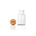Empty Rivsalt glass jar with its cork stopper beside it