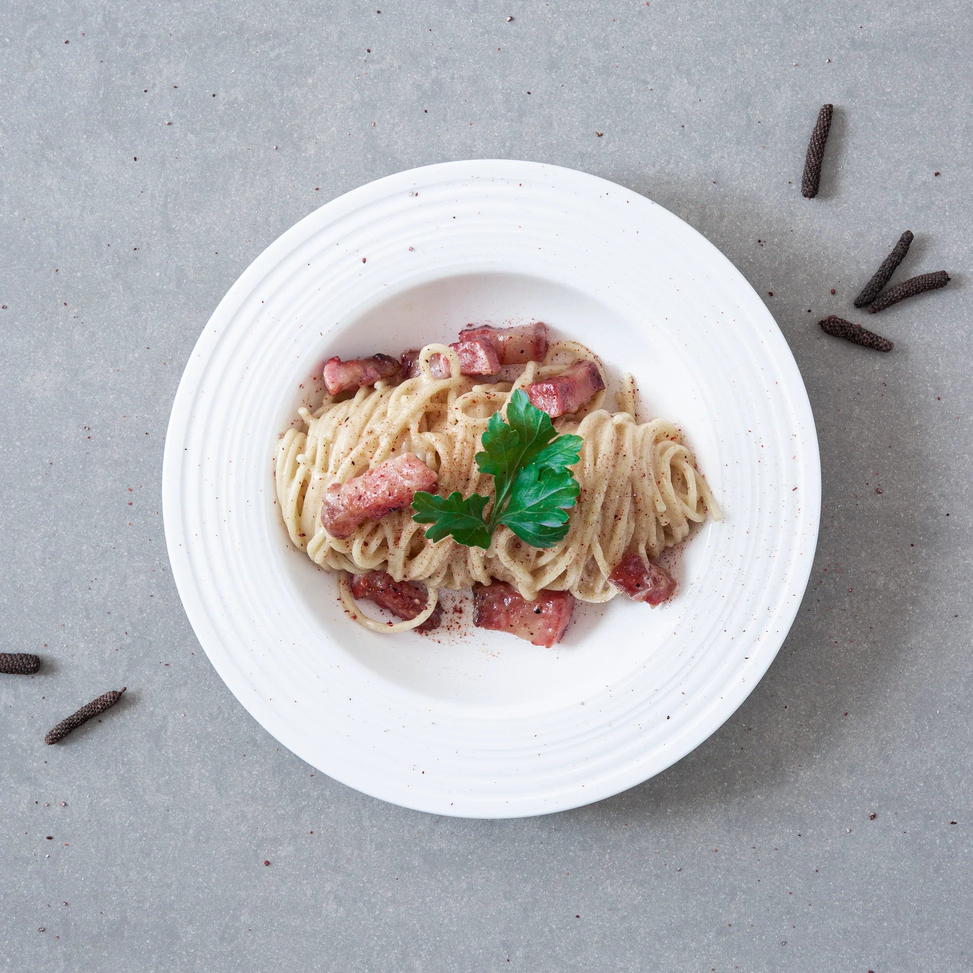 Plate of pasta carbonara garnished with Rivsalt Java Long Pepper