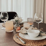 Rivsalt The Original Salt Grater on a dinner table set with wine glasses and a woven placemat