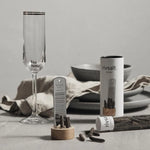 Rivsalt Pepper Stainless Steel Grater on a table set with a champagne flute and linen