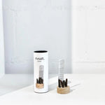 Rivsalt Pepper Stainless Steel Grater with long pepper on a wooden stand beside its white tube